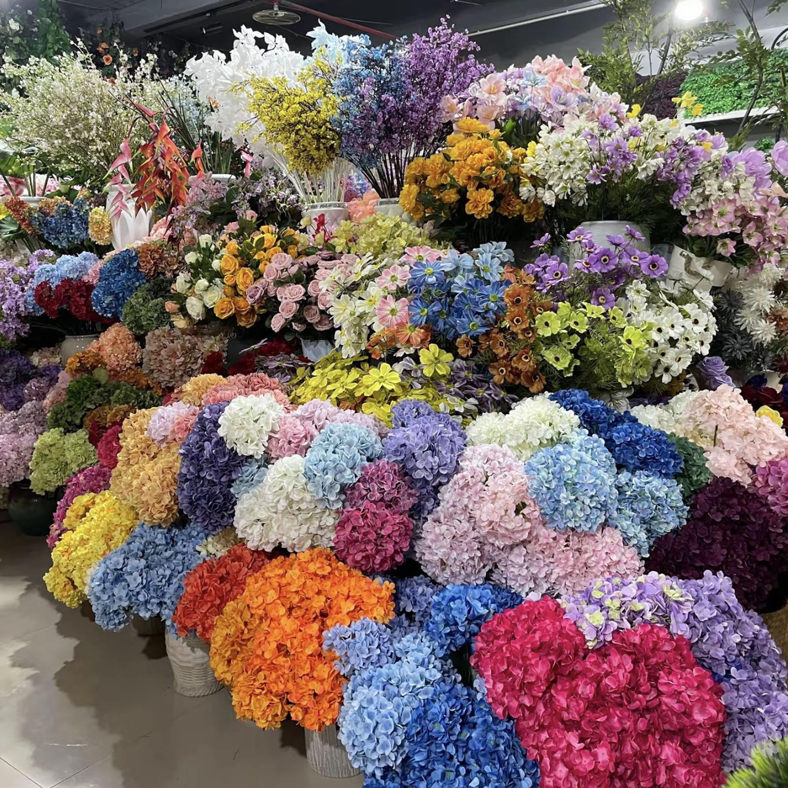 Bulk stock of multicolor artificial hydrangeas at PJTL factory, ready for wholesale supply