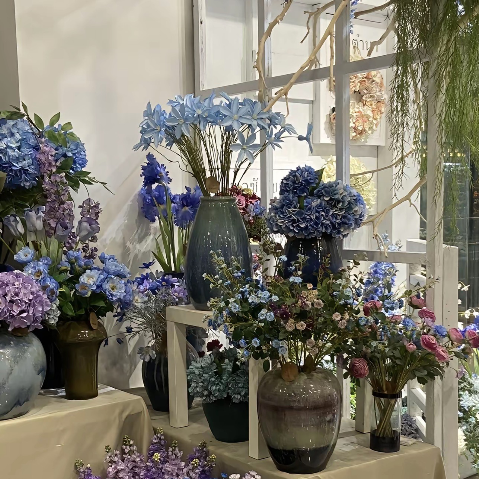 Blue and purple artificial hydrangea and rose display at PJTL wholesale showroom, Shantou China