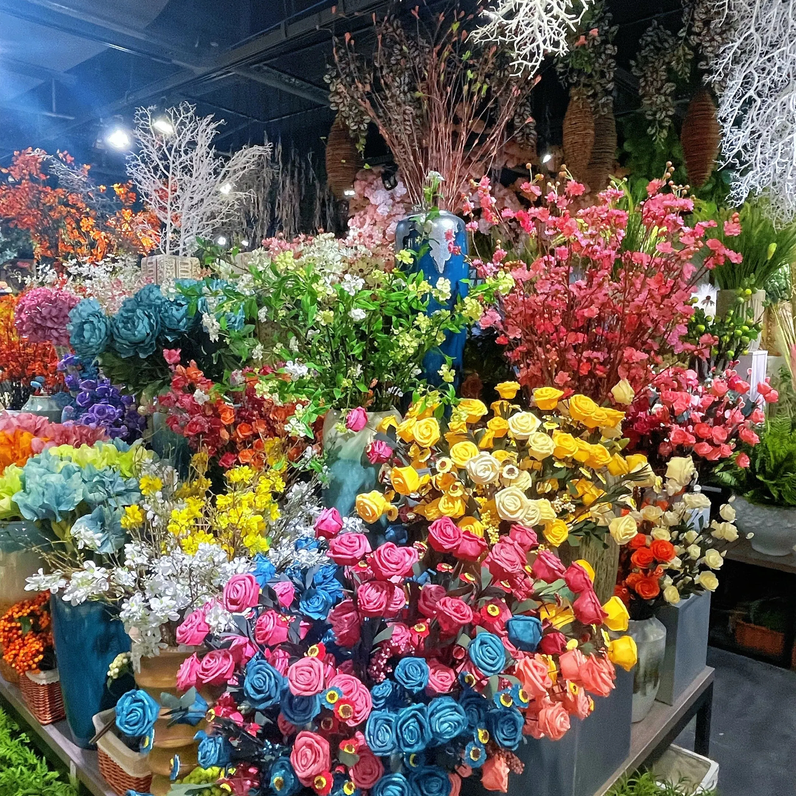 Vibrant multicolor artificial roses and cherry blossom branches on display at PJTL showroom