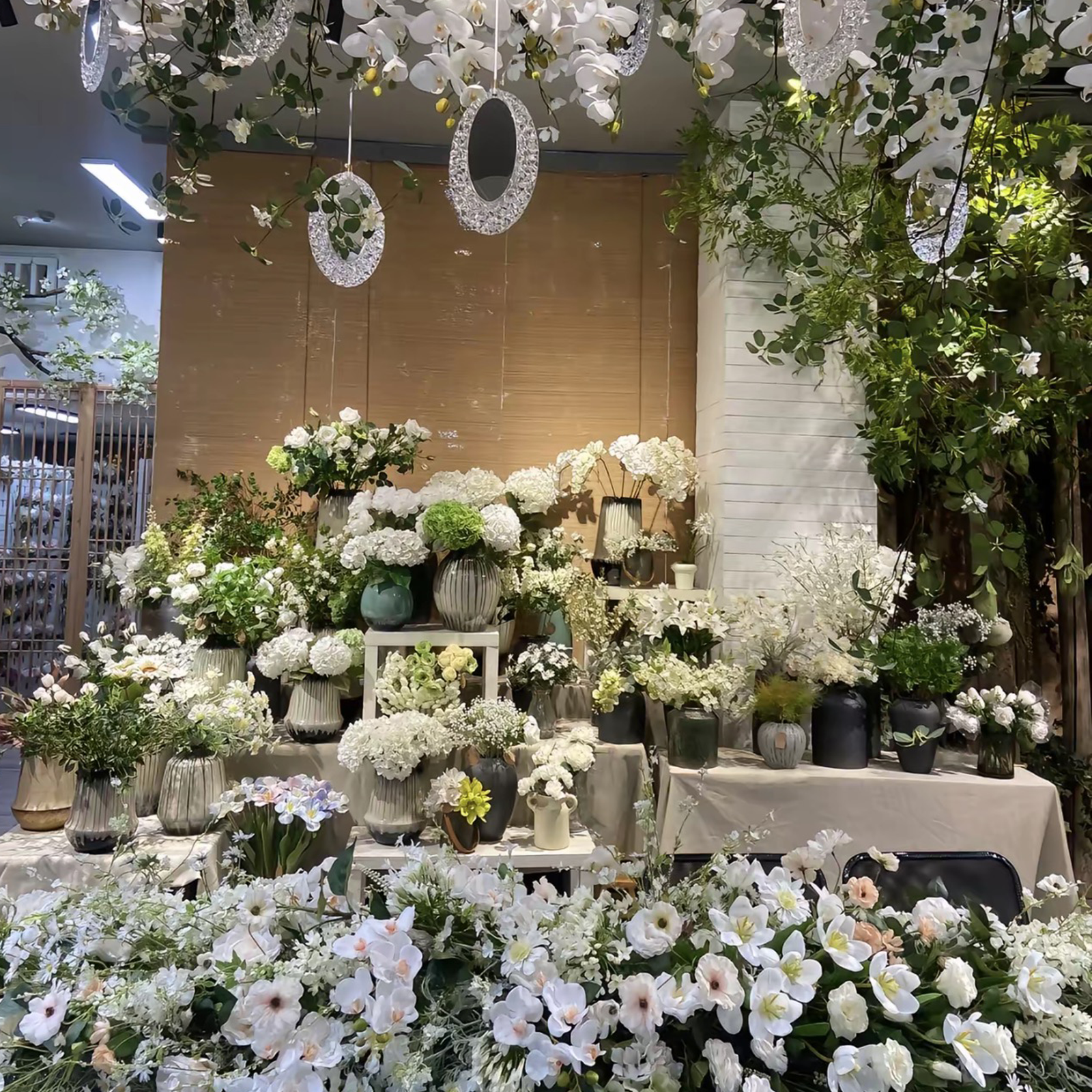 White artificial hydrangea and orchid display with hanging decor at PJTL wholesale showroom, China