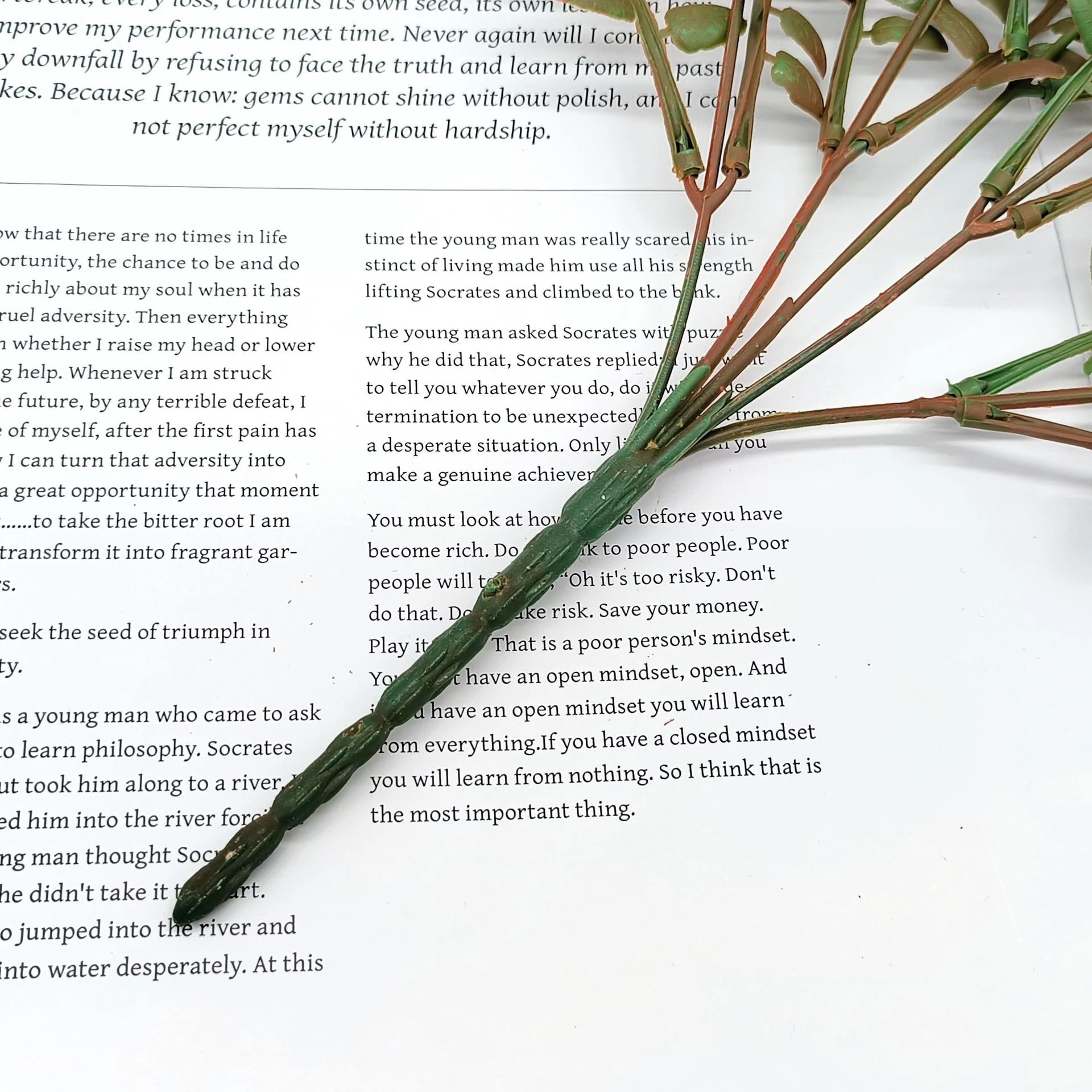 Close-up of the bundled stem base on an artificial autumn fern leaf bush