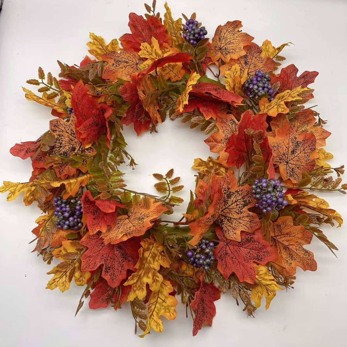 Artificial autumn maple leaf wreath with purple berry clusters