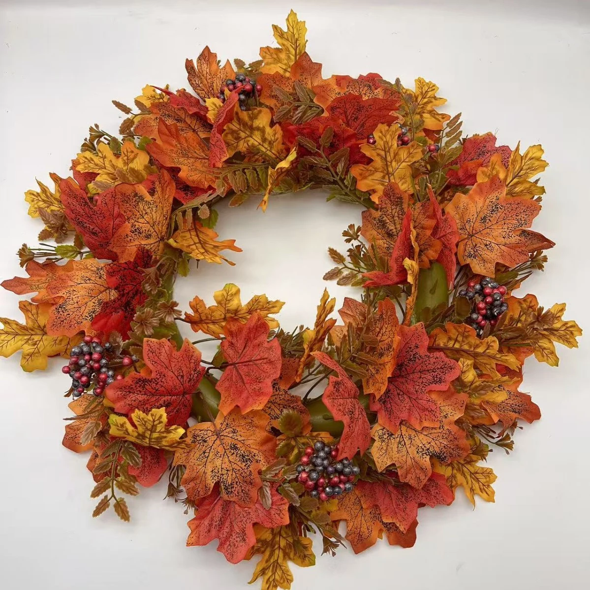 Artificial autumn maple leaf wreath with red berry clusters