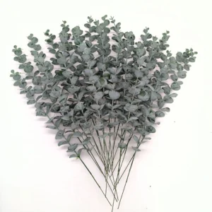 Bulk display of artificial baby silver dollar eucalyptus stems viewed from above