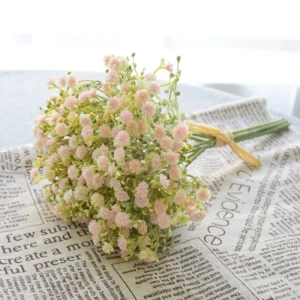 Blush pink artificial baby's breath bouquet arranged on a newspaper backdrop