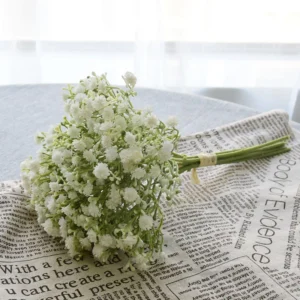 White artificial baby's breath bouquet arranged on a newspaper backdrop