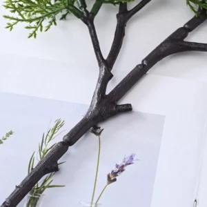 Branch and foliage attachment detail shared by layered-cloud and dense-cluster artificial bonsai stems
