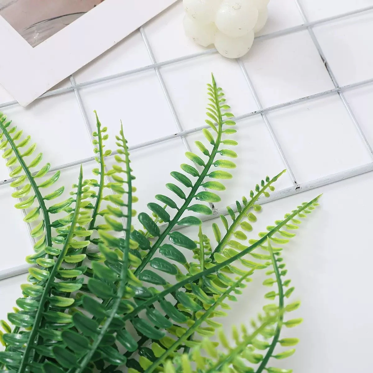 Detailed view of mixed-green artificial Boston fern fronds