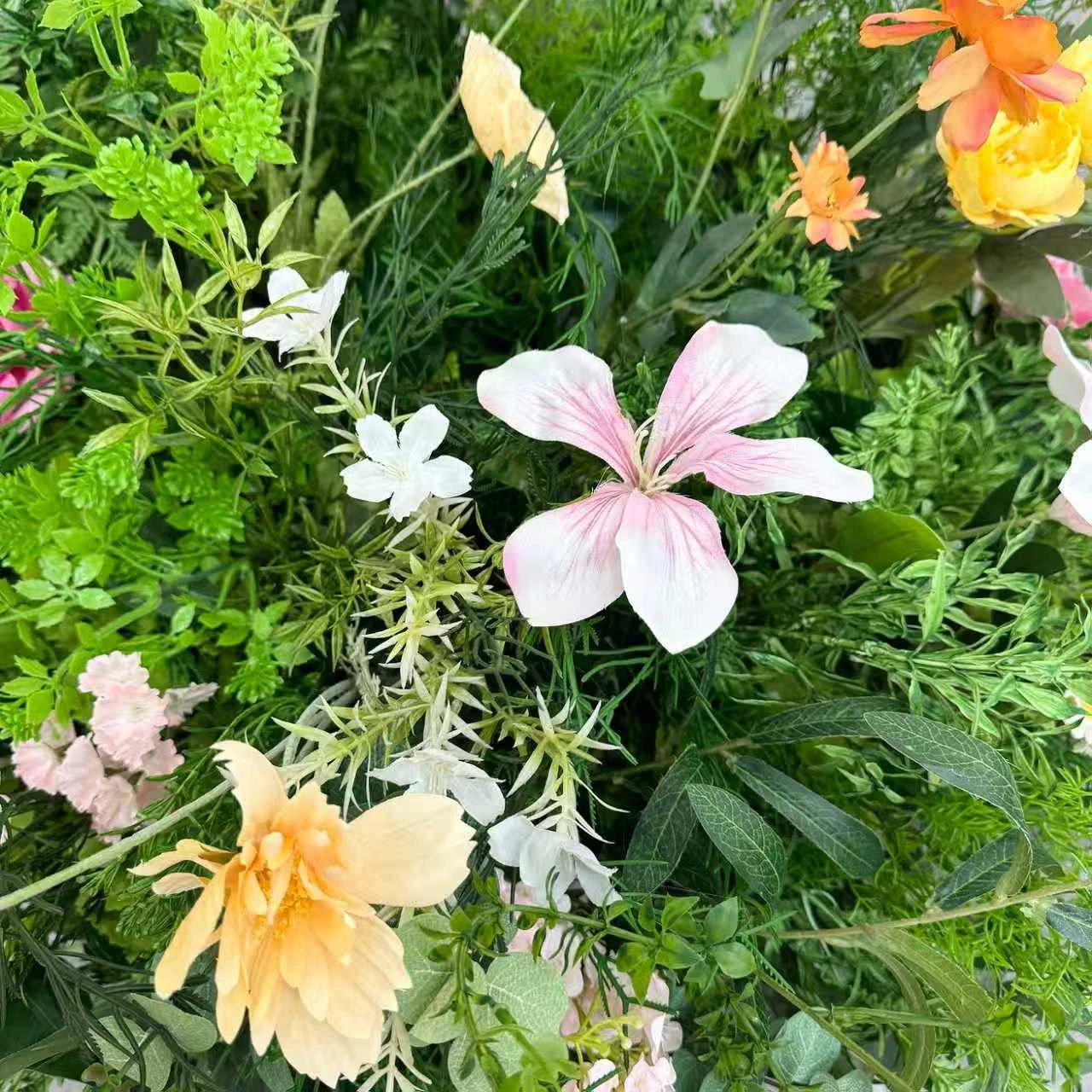 Close-up of artificial cascading wedding aisle flower arrangement