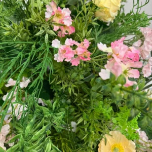 Close-up of pink artificial cascading wedding aisle flower arrangement
