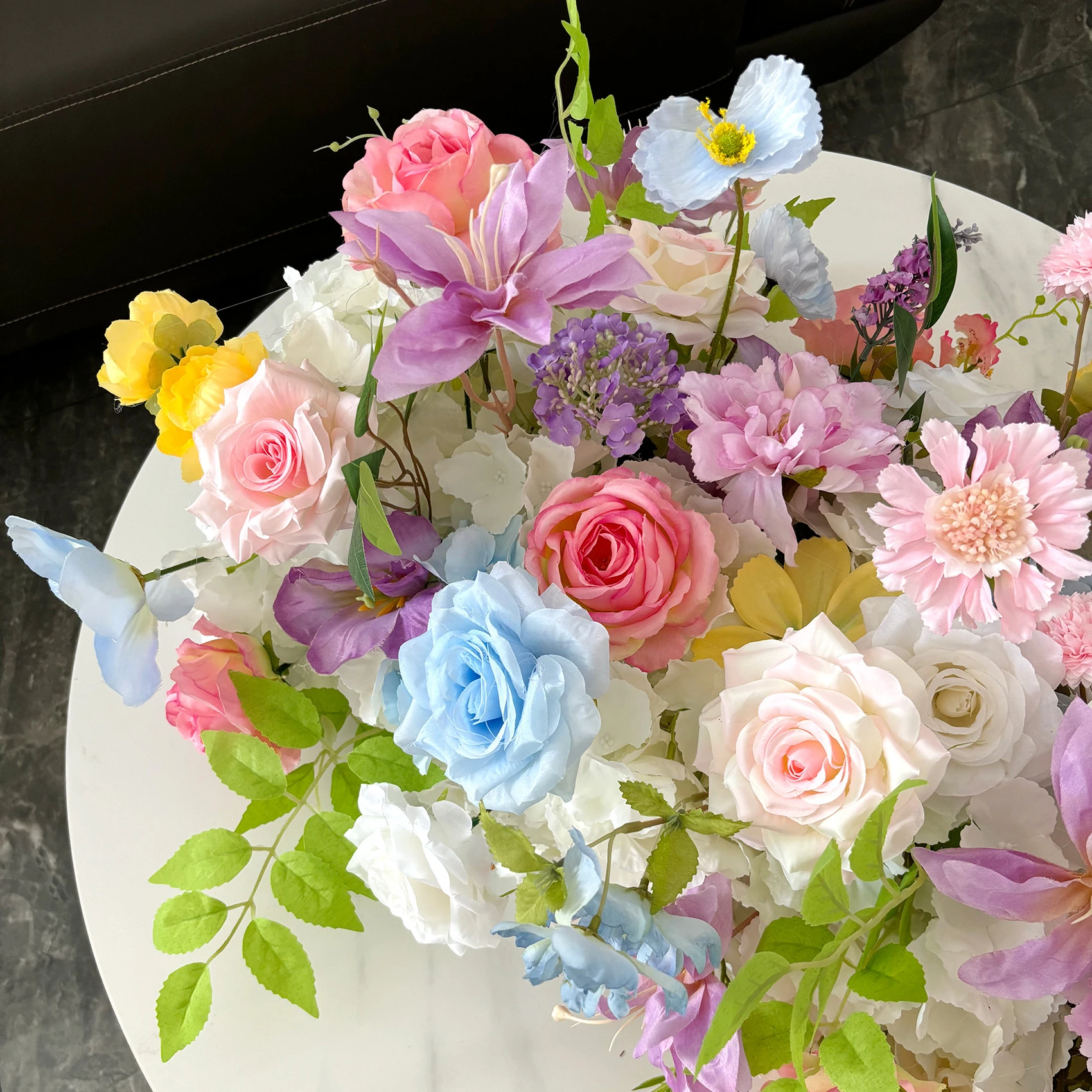 Close-up of pastel garden artificial cascading wedding table flower arrangement collection
