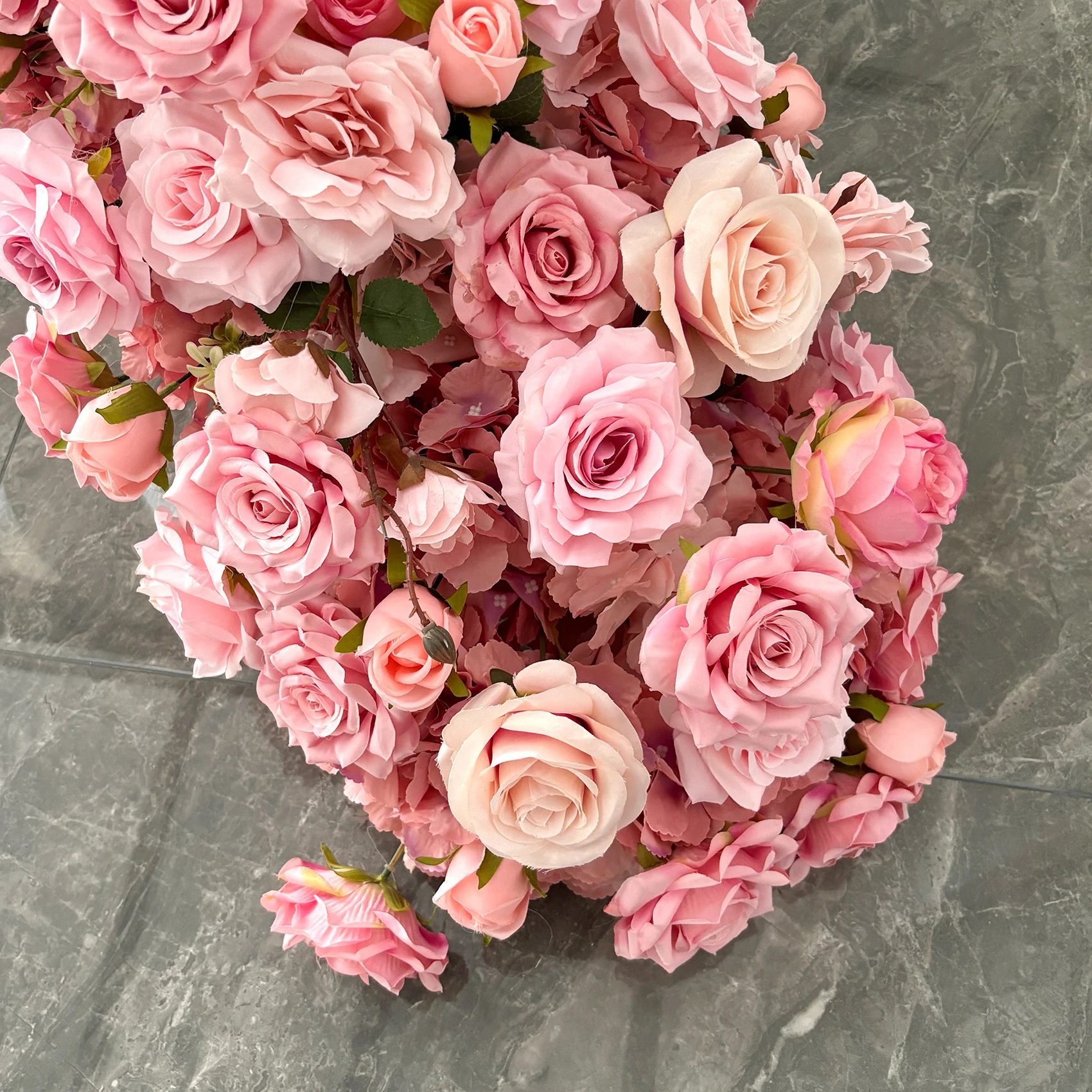 Close-up of pink rose artificial cascading wedding table flower arrangement collection