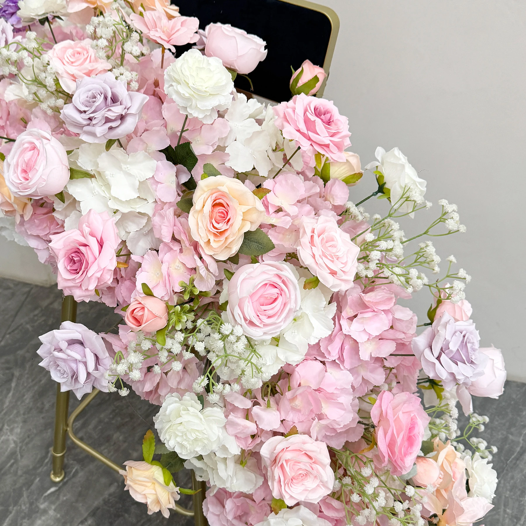 Close-up of pink rose artificial cascading wedding table flower arrangement collection