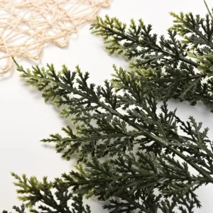 Close-up of mixed green foliage tips on artificial cedar garland