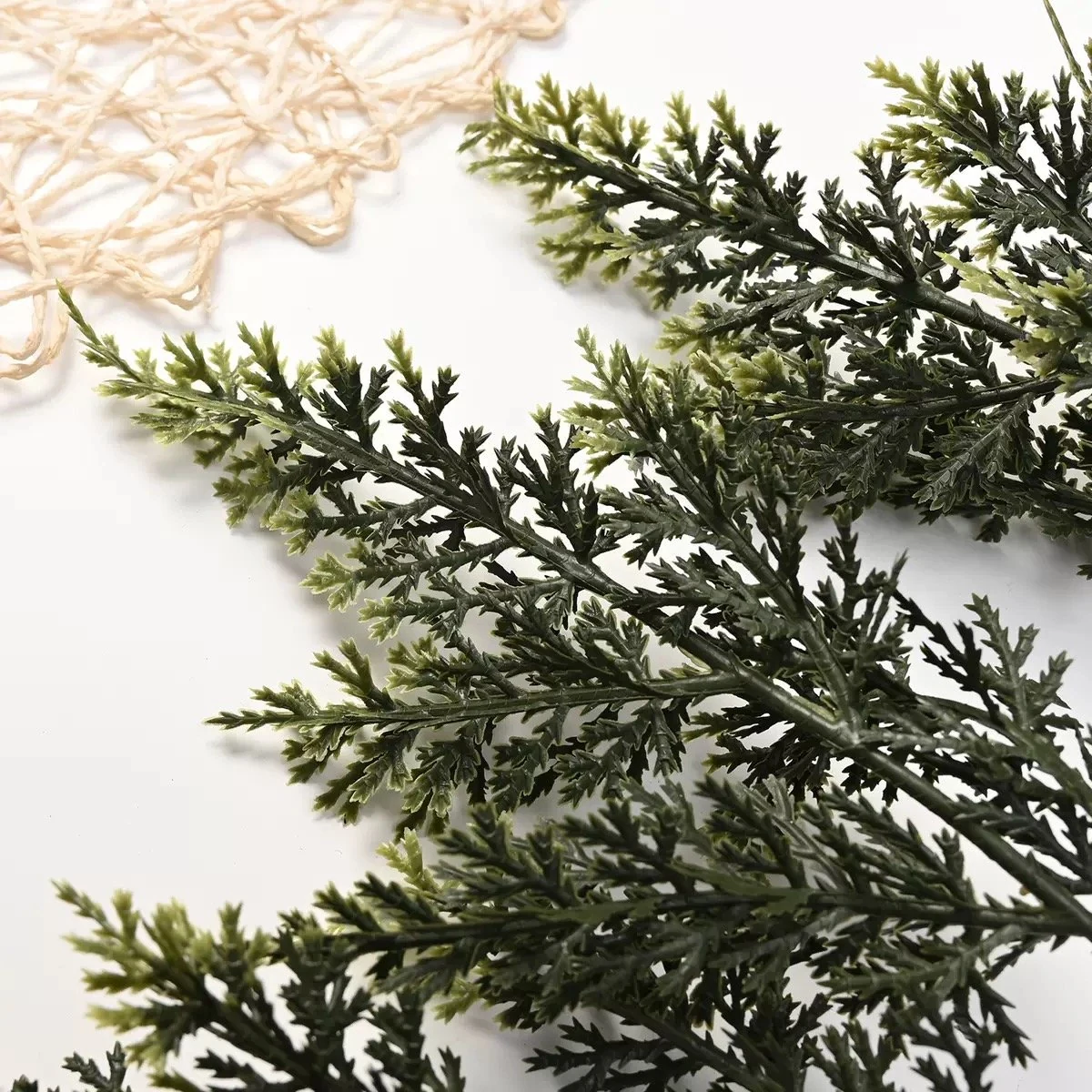 Close-up of mixed green foliage tips on artificial cedar garland