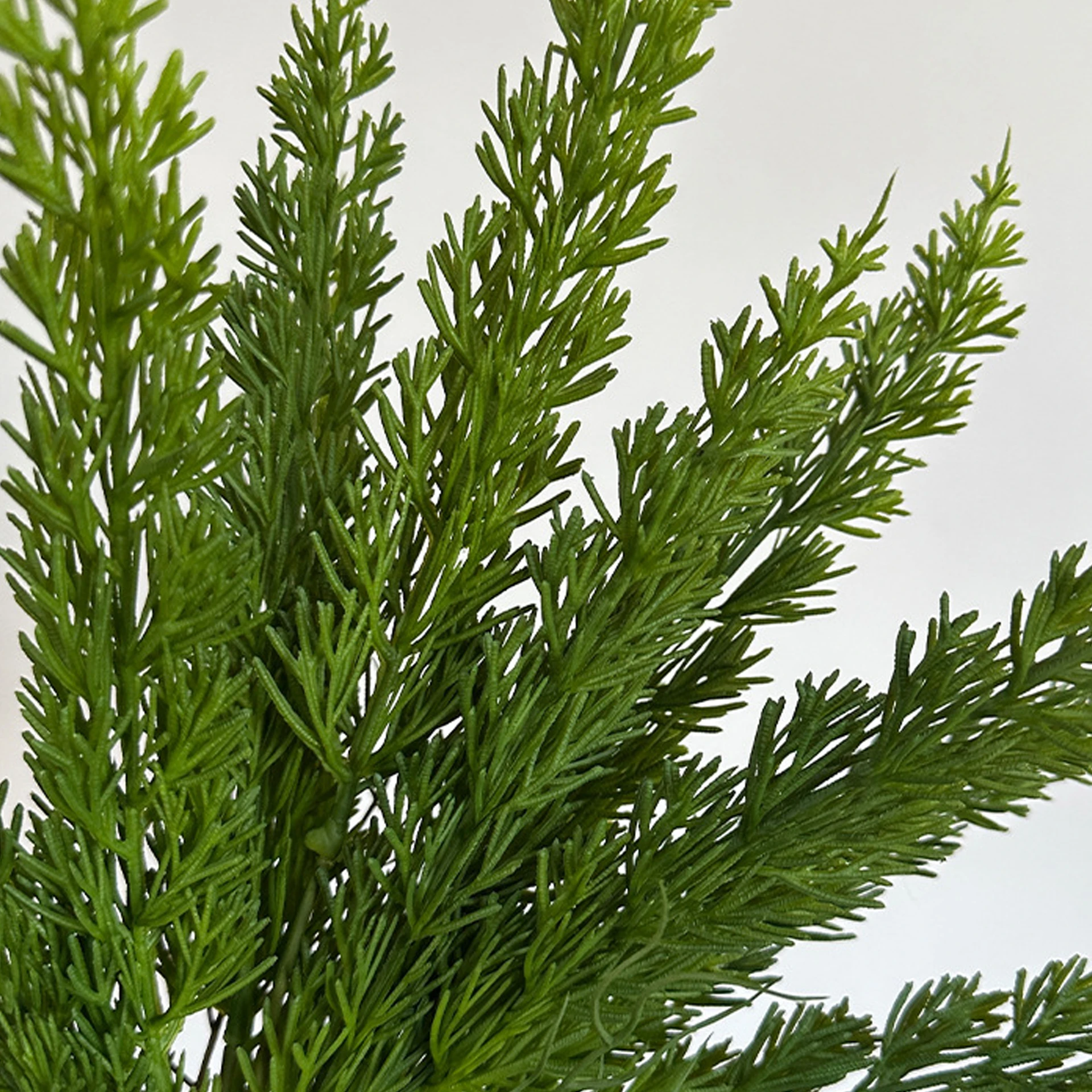Close-up of dark green artificial cedar greenery bush
