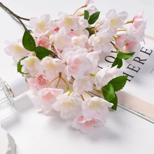 Light pink artificial cherry blossoms arranged in a tabletop display