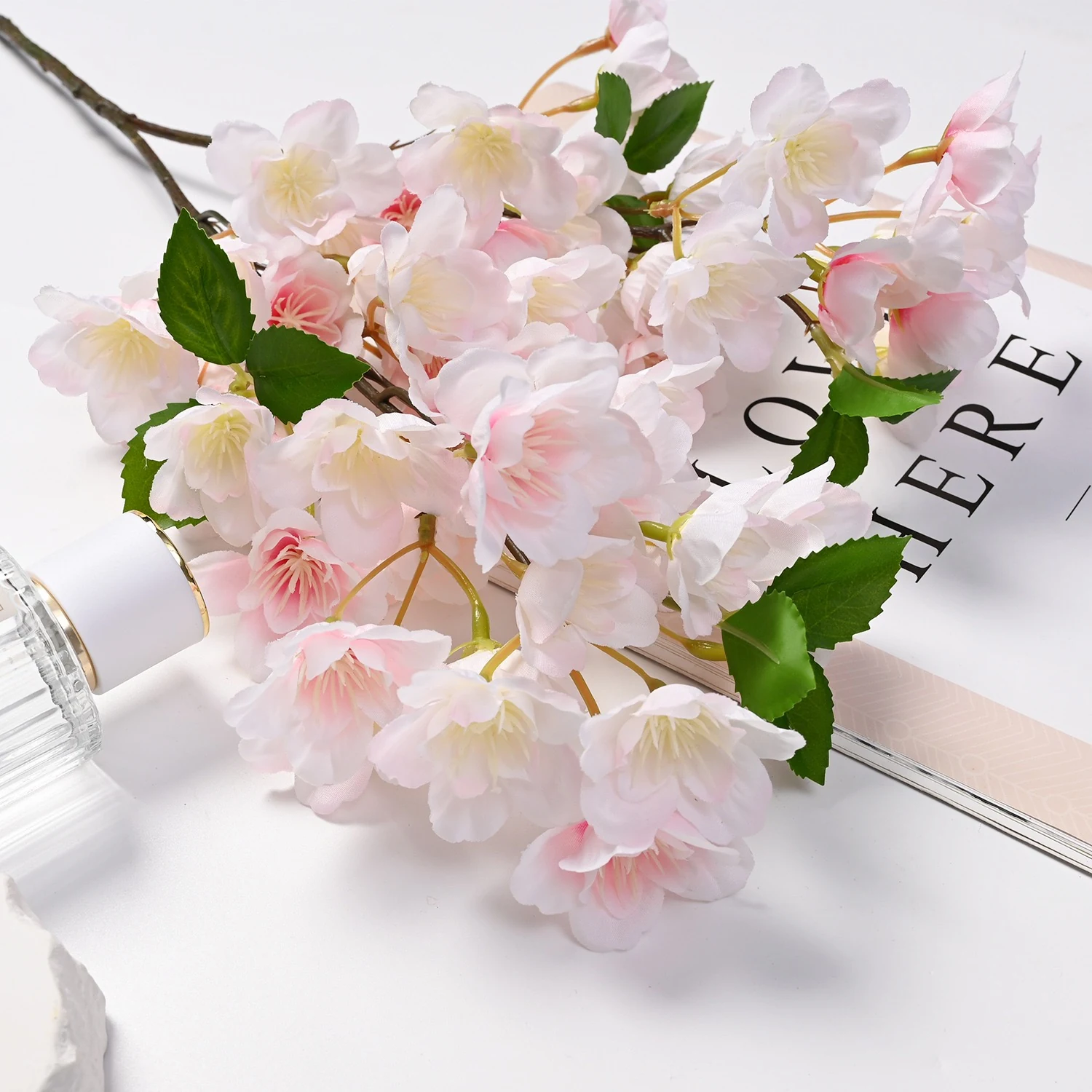 Light pink artificial cherry blossoms arranged in a tabletop display