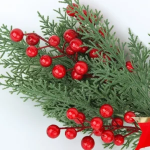 Close-up of red berries on artificial Christmas swag