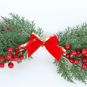 Red and gold bow detail on artificial cypress Christmas swag