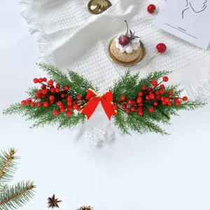 Artificial Christmas cypress and red berry swag in a table display