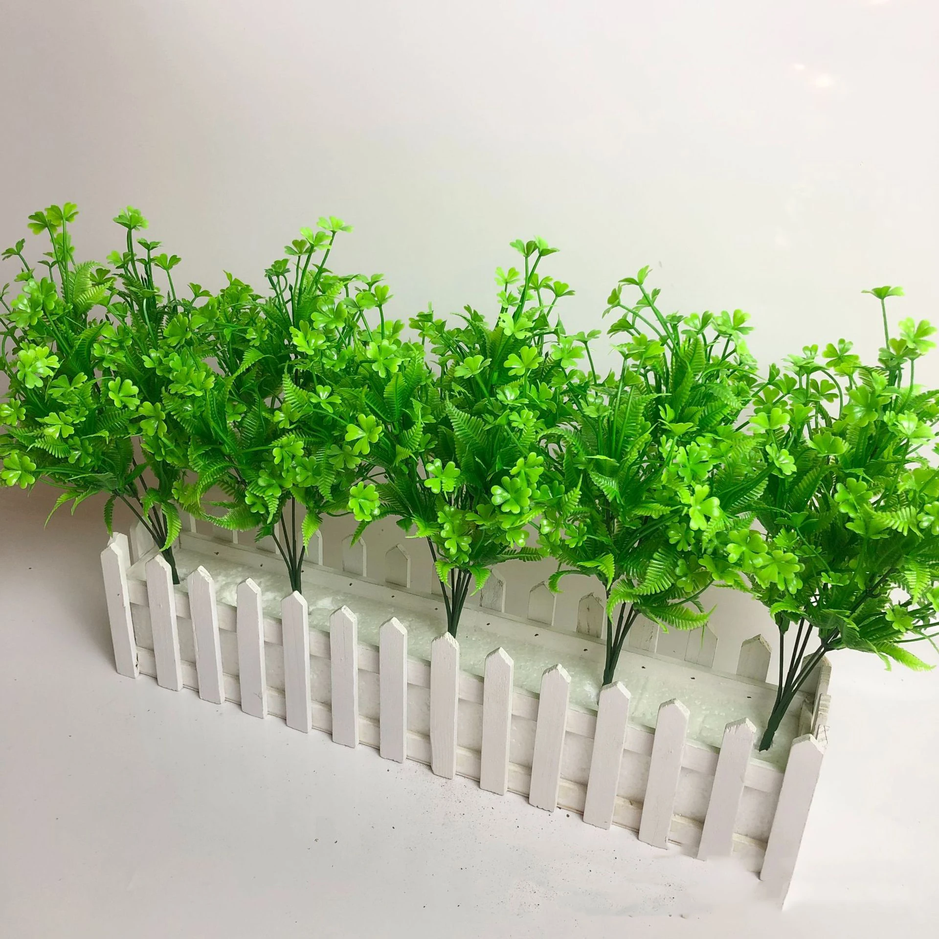 Artificial Clover and Fern Greenery Bush arranged for decorative display