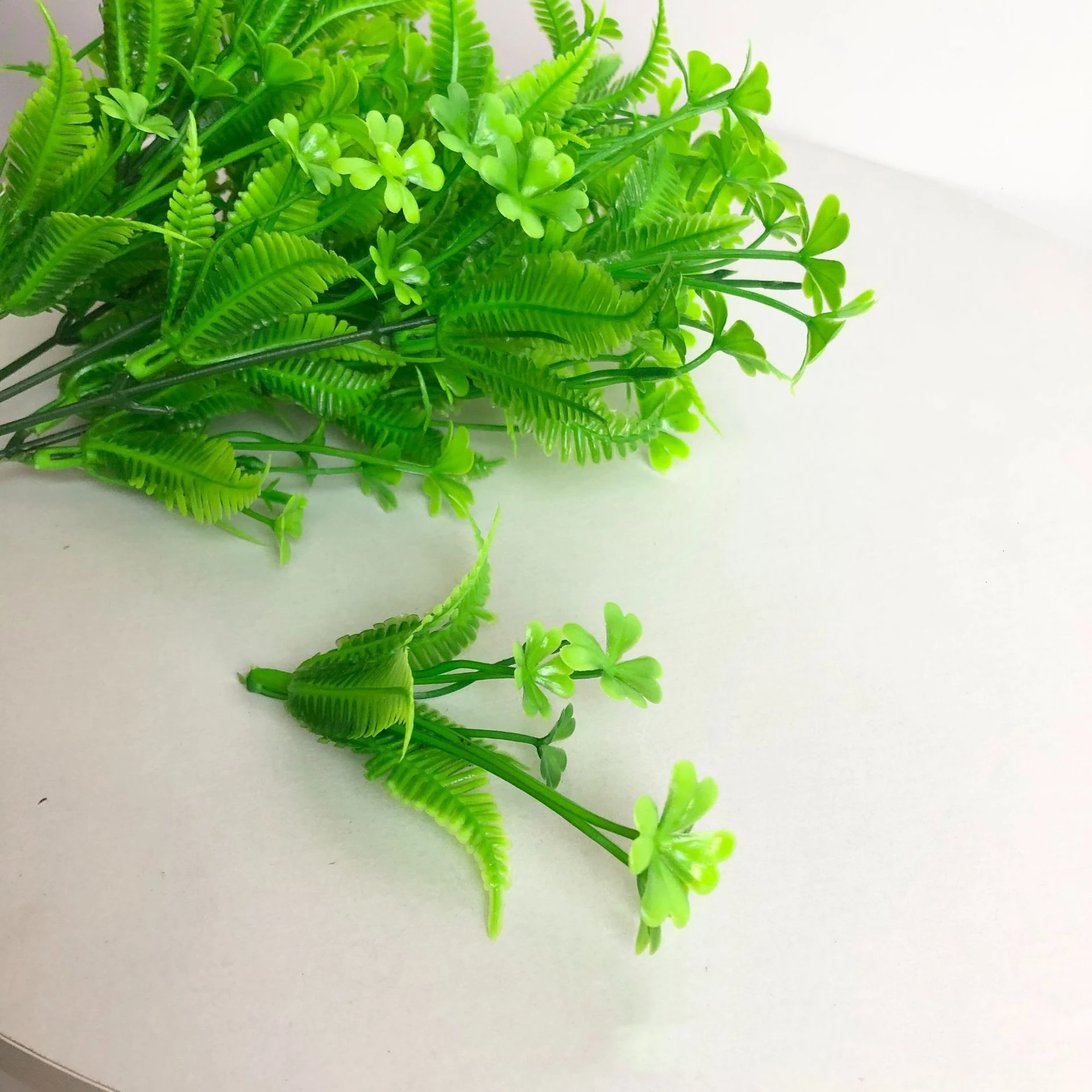 Close-up of artificial Clover and Fern Greenery Bush branch