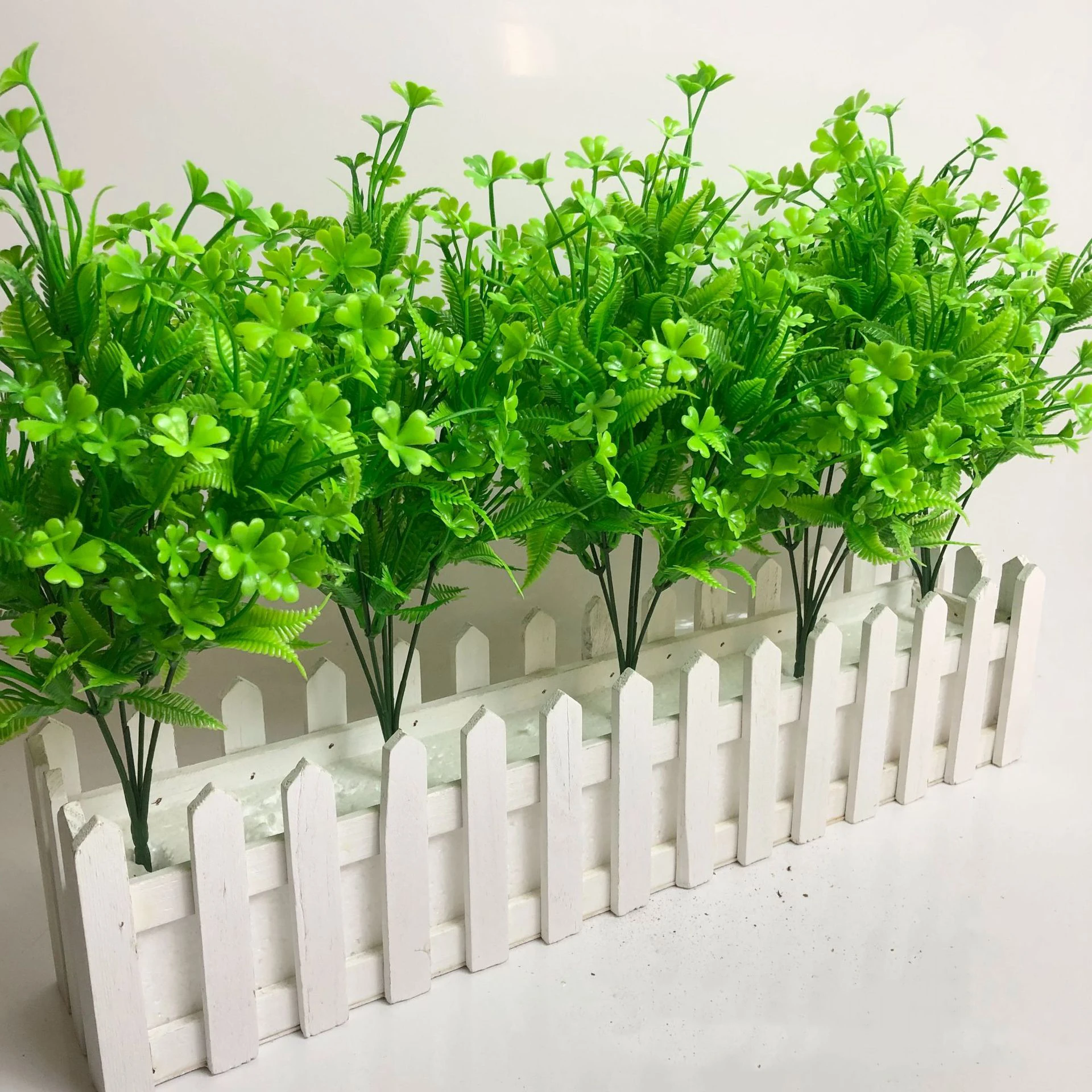 Artificial Clover and Fern Greenery Bush arranged for decorative display