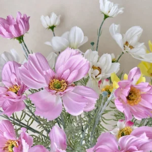 Close-up of pink artificial cosmos flower spray