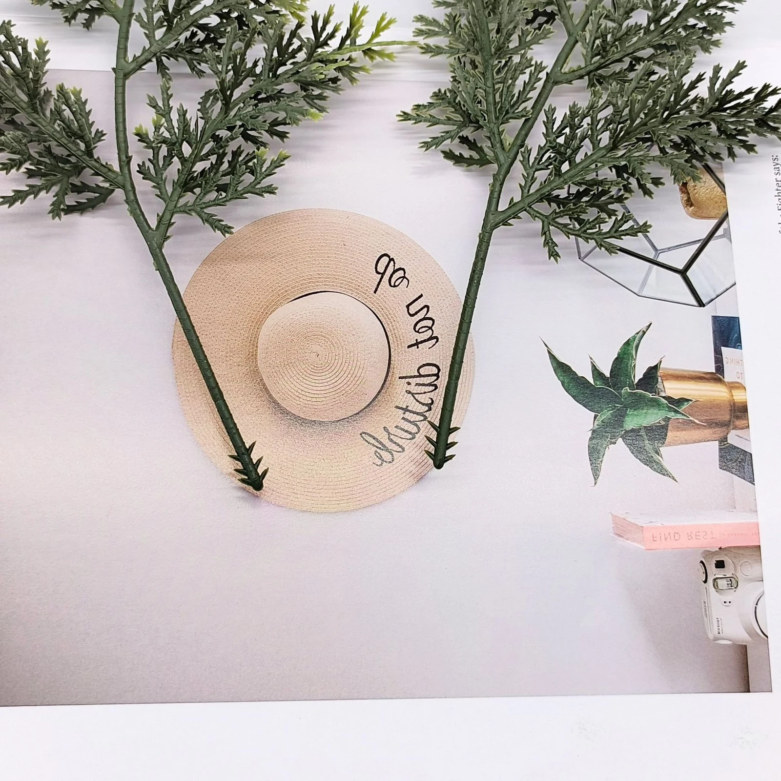 Pair of green artificial cypress branches in a styled decorative display
