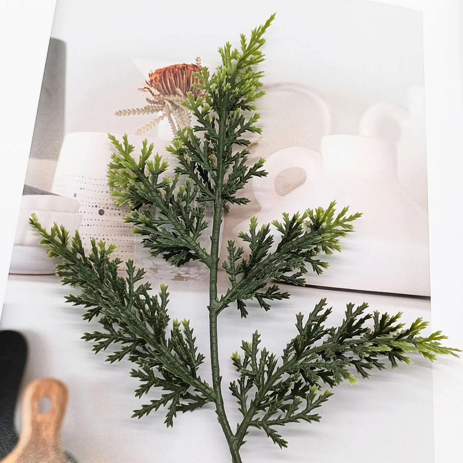 Close-up of green artificial cypress foliage with lighter tips