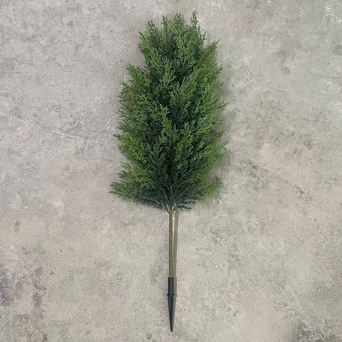 Full artificial cypress topiary tree laid flat with ground spike