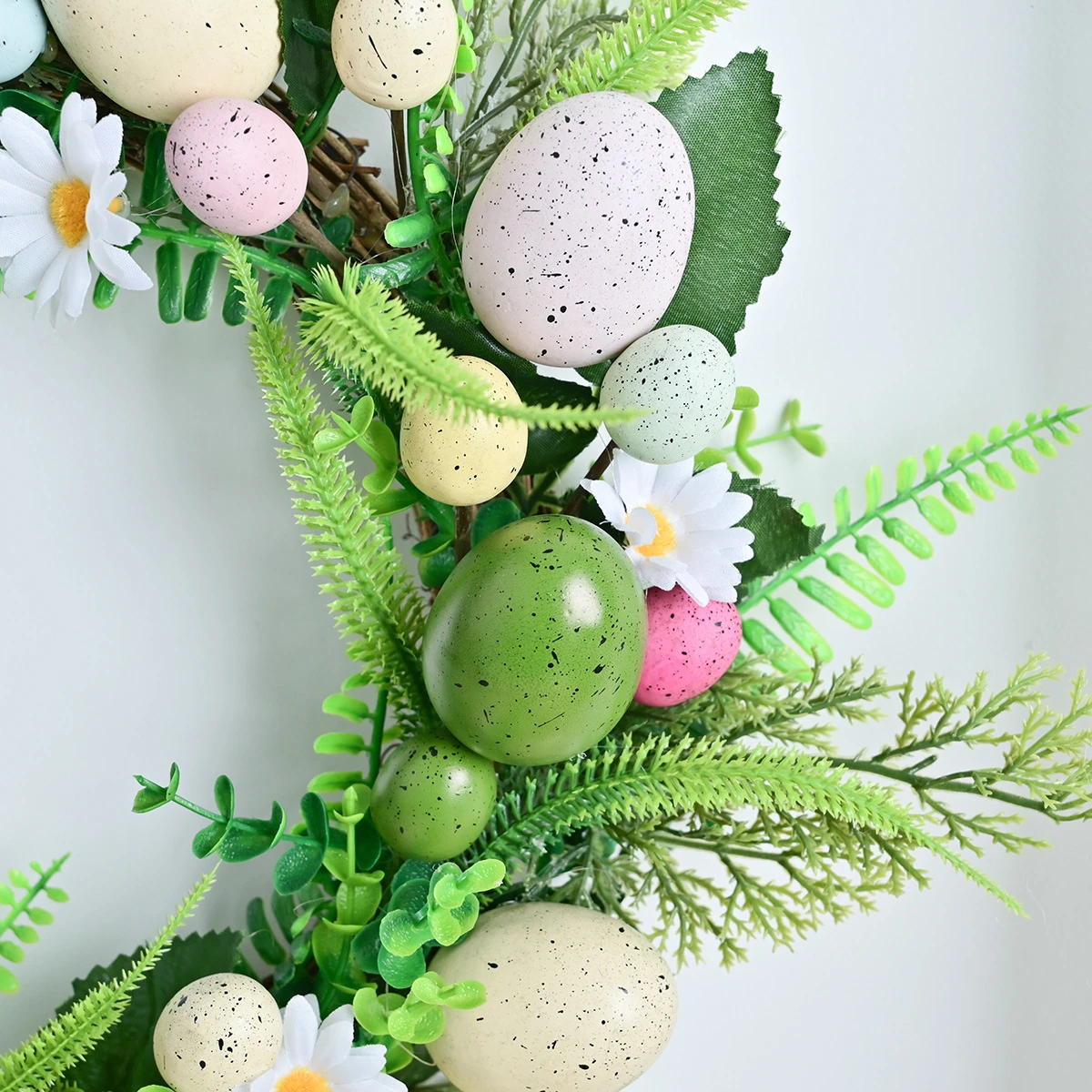 Close-up of detail artificial daisy fern easter egg wreath