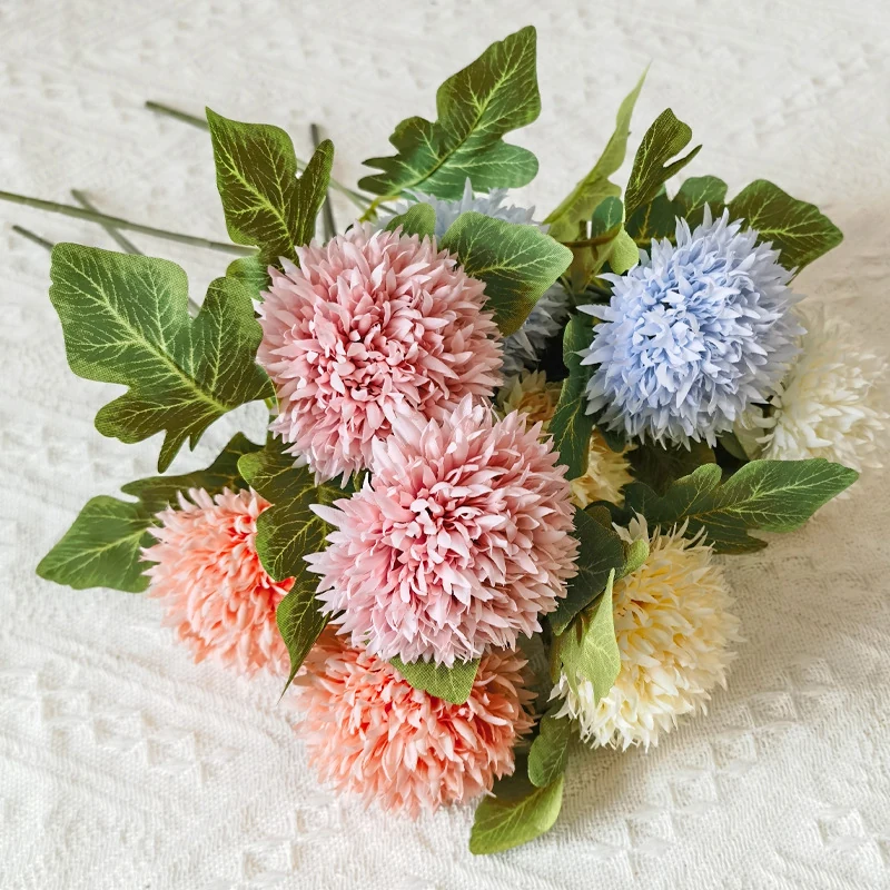 Mixed pink, light blue and white artificial pompon chrysanthemum stems arranged together