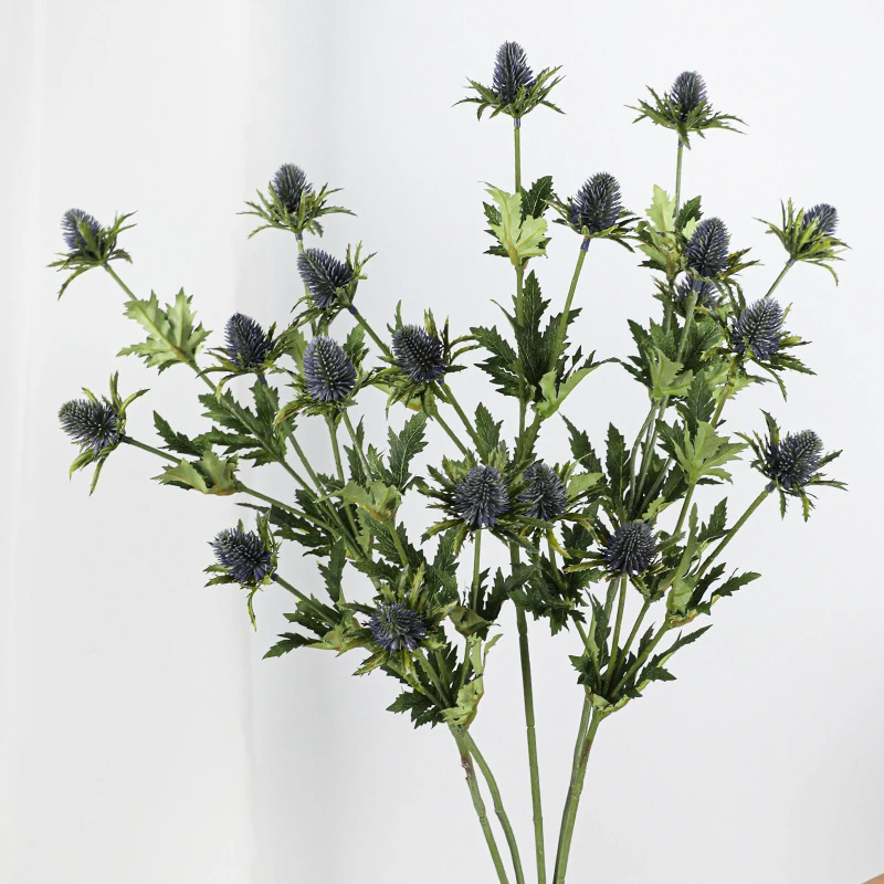 Handheld view of dark purple artificial eryngium thistle spray