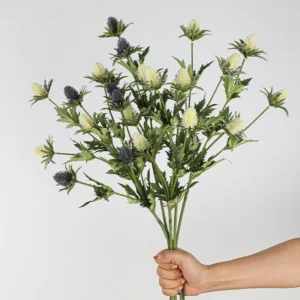 Handheld view of white artificial eryngium thistle spray
