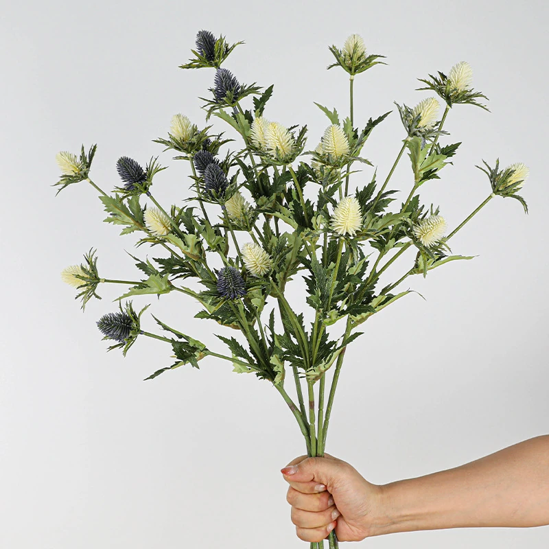 Handheld view of white artificial eryngium thistle spray