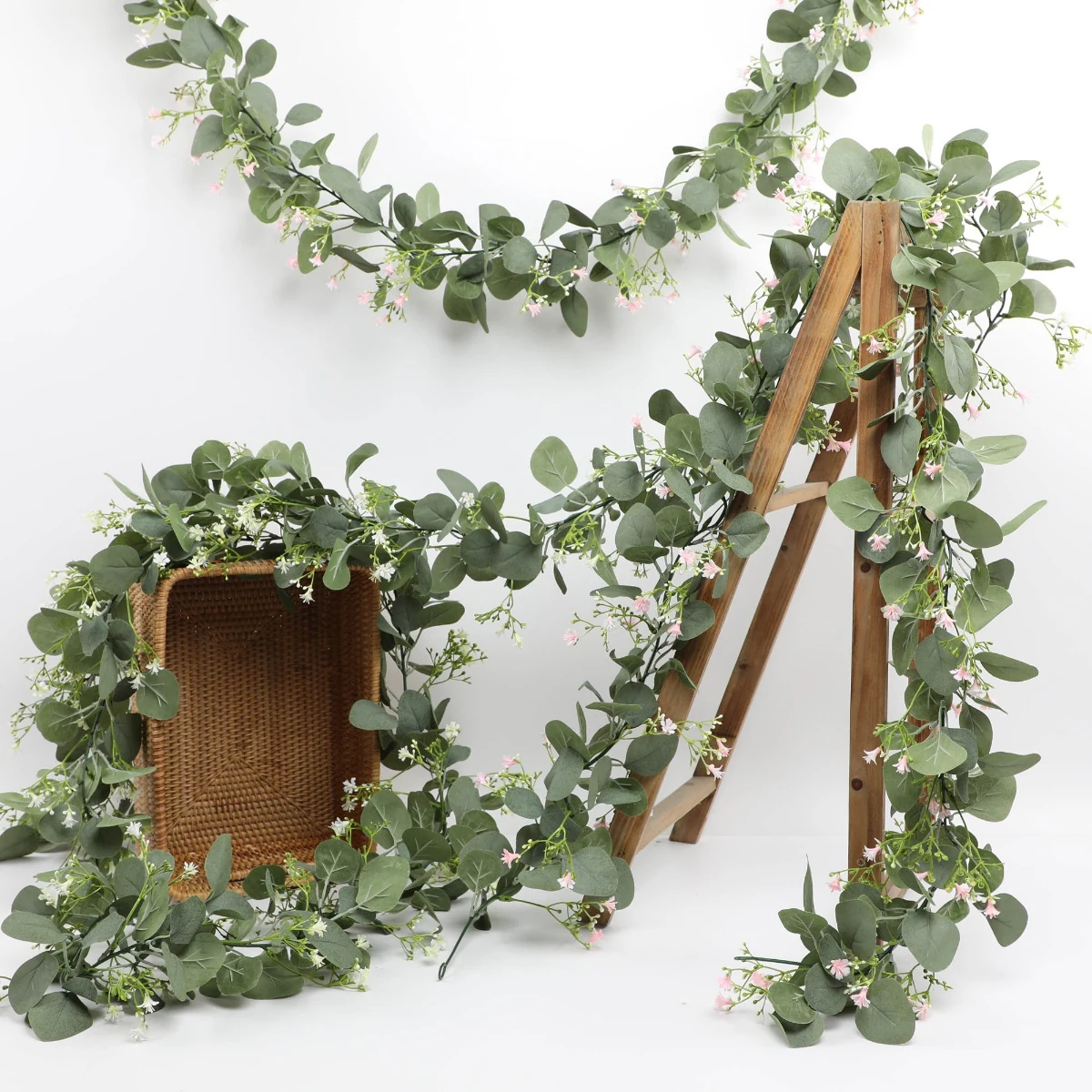 Artificial eucalyptus garlands with baby's breath arranged on display stands
