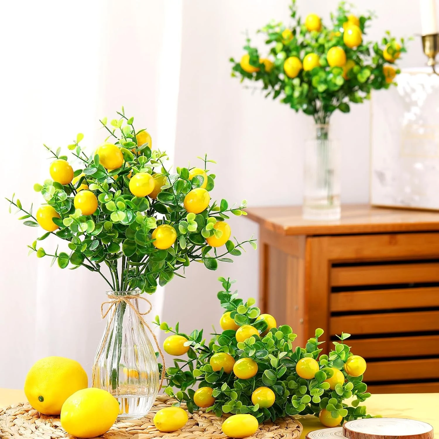 Artificial eucalyptus lemon berry bushes arranged in glass vases