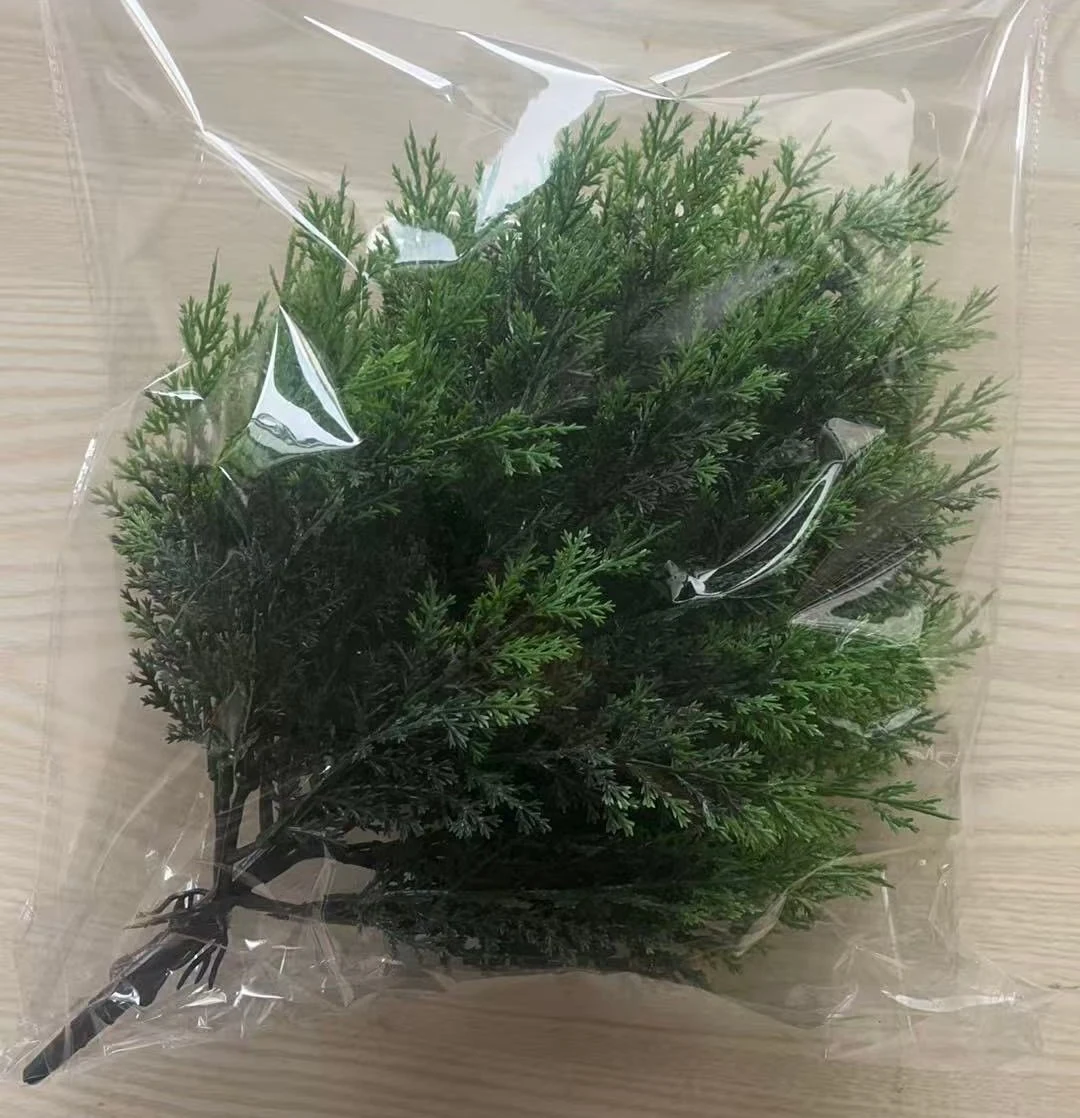 Rounded artificial evergreen bush packed in a protective bag