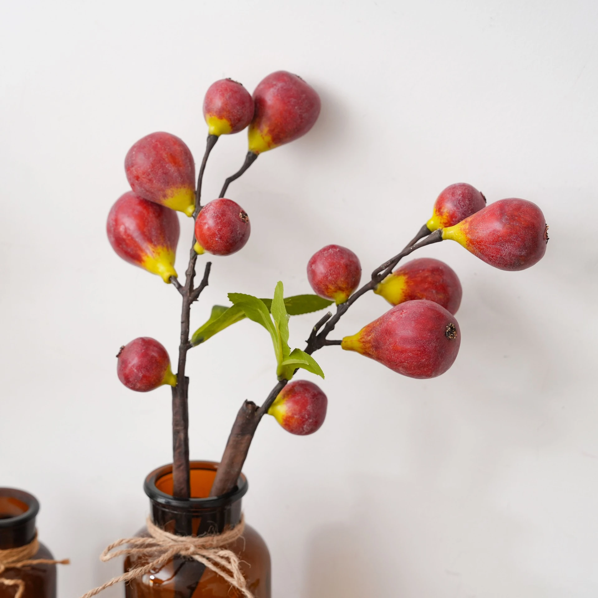 Application display of red artificial fig fruit stem