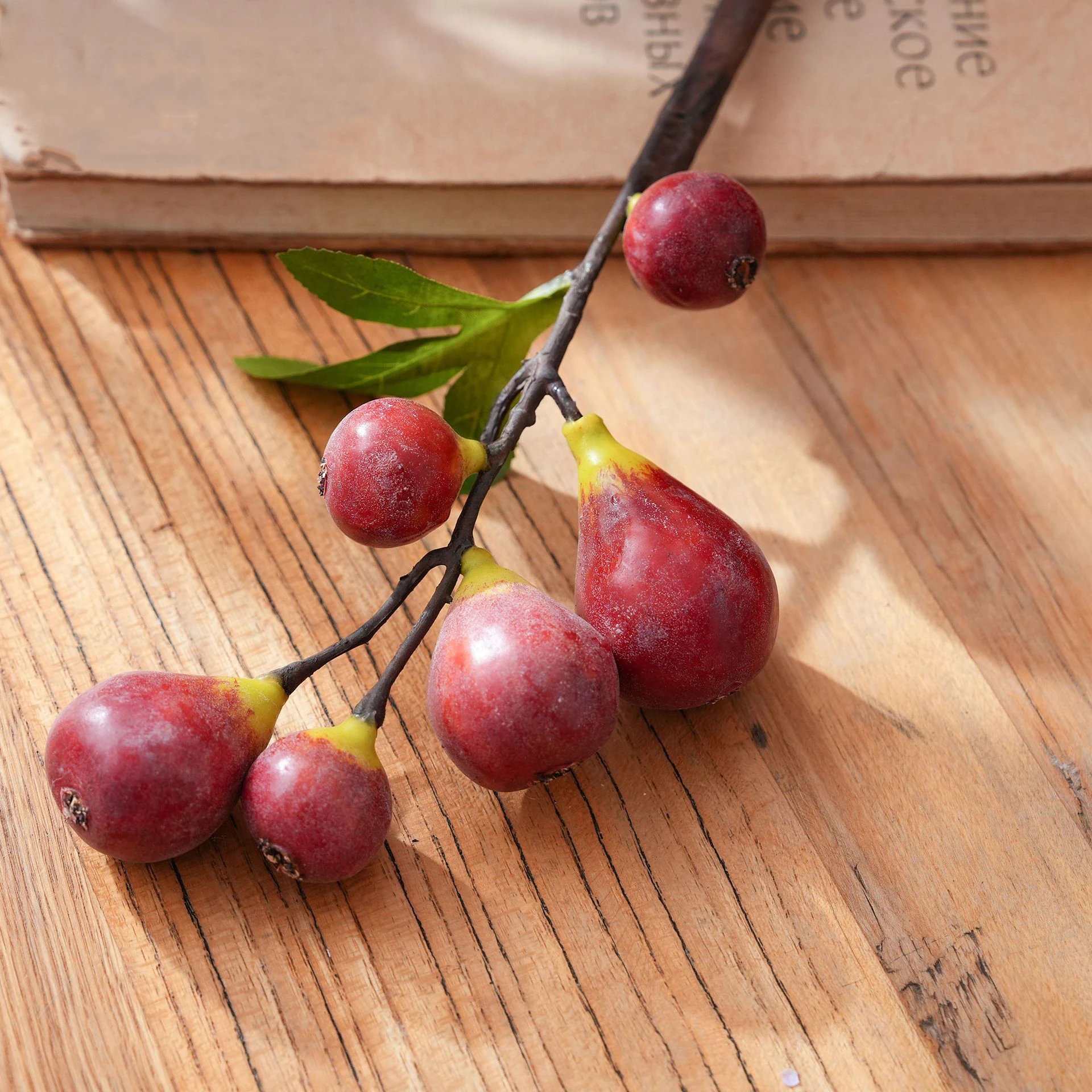 Close-up of red artificial fig fruit stem
