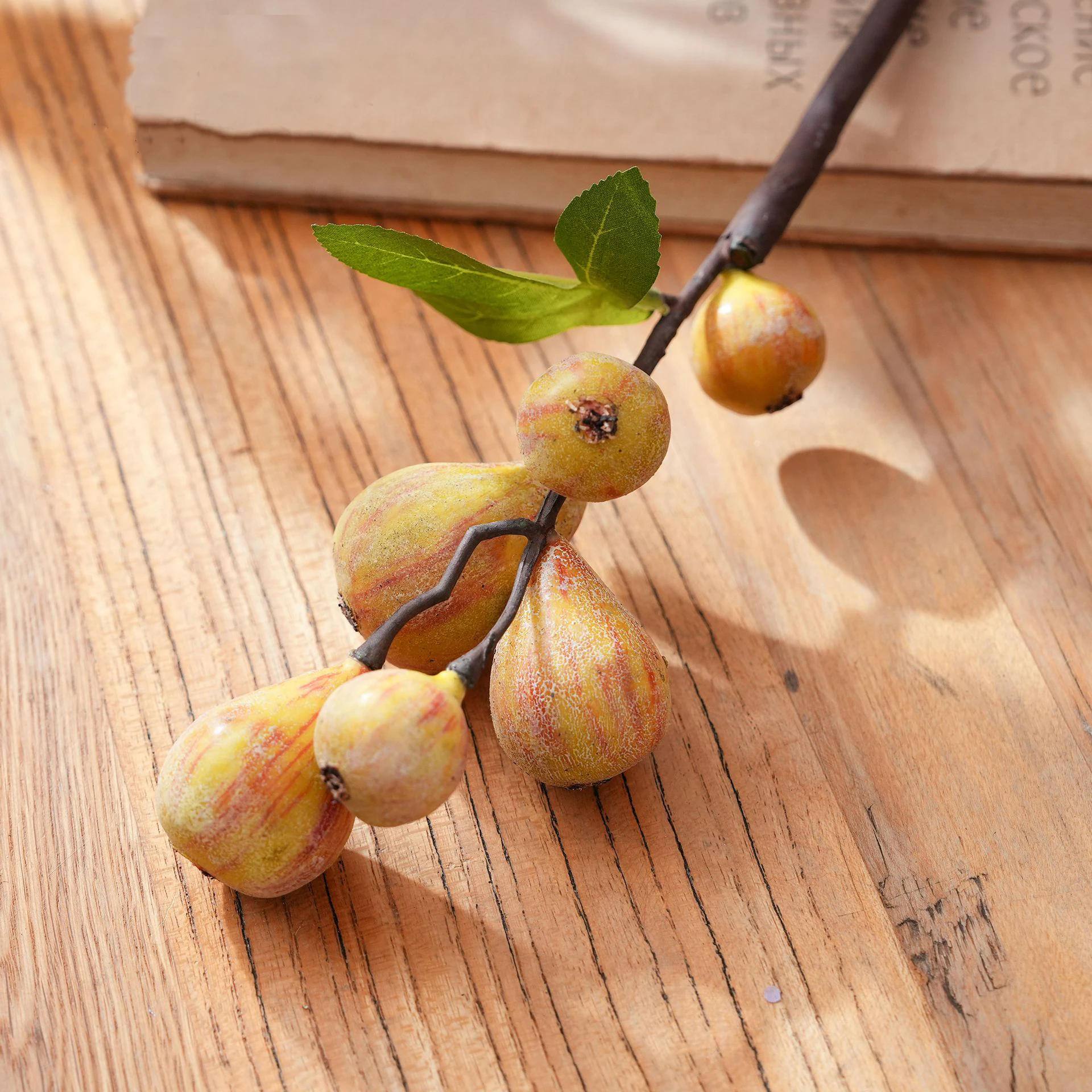 Close-up of yellow artificial fig fruit stem
