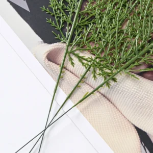 Close-up of fine green branchlets on artificial flat cedar foliage sprays