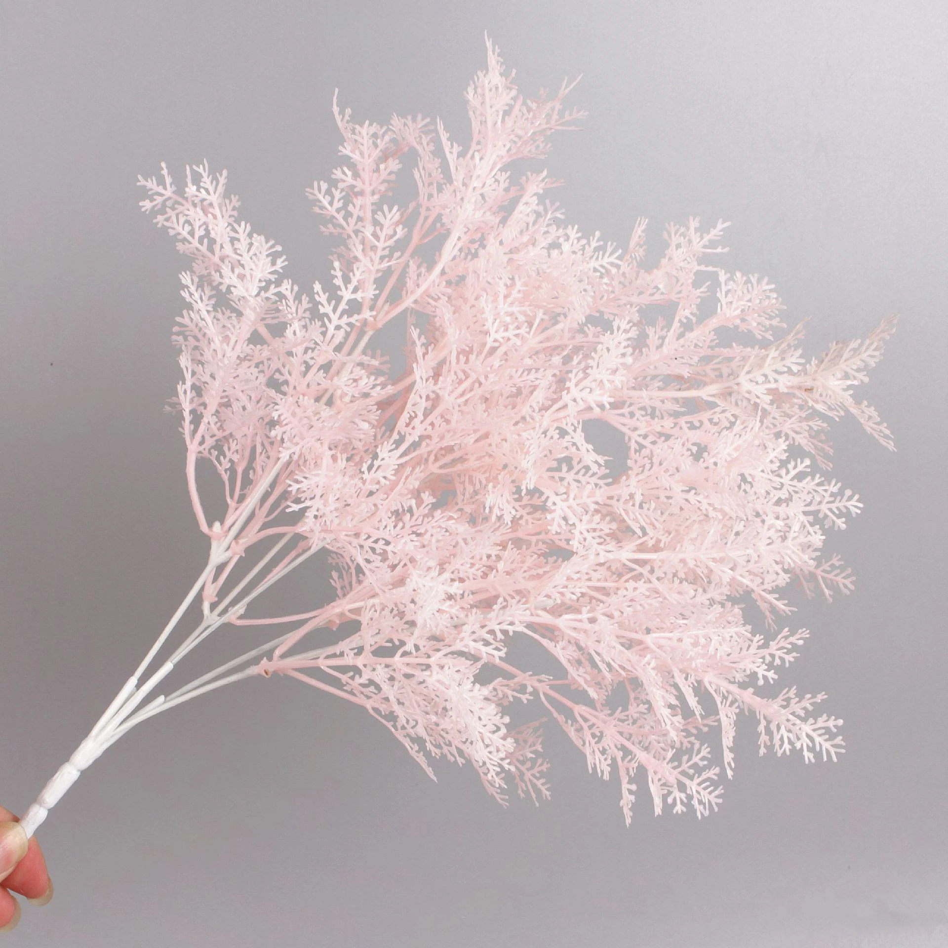 Close-up of artificial Flocked Asparagus Fern Bush branch