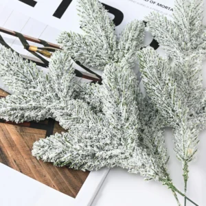 Multiple artificial flocked snow pine picks laid flat
