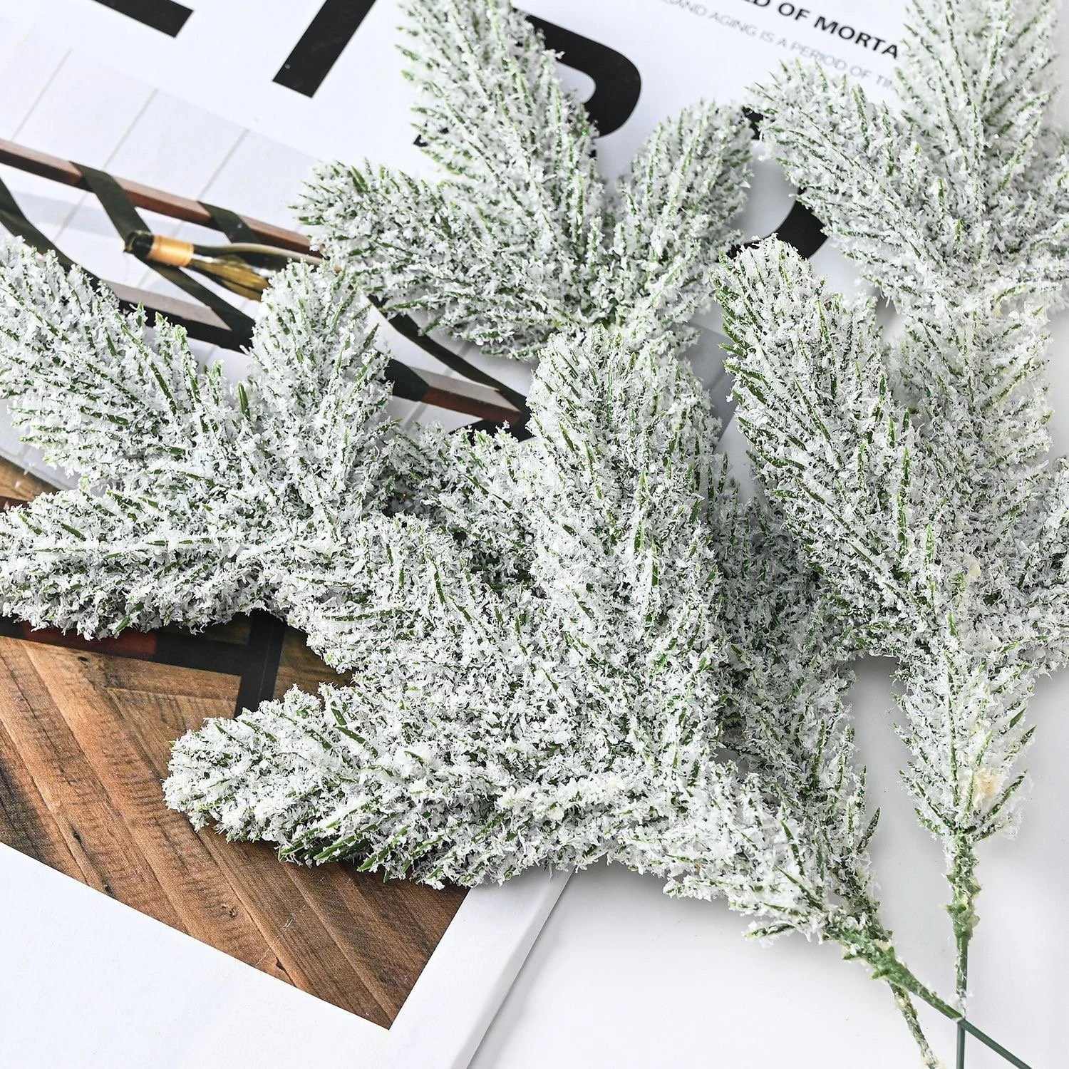 Multiple artificial flocked snow pine picks laid flat