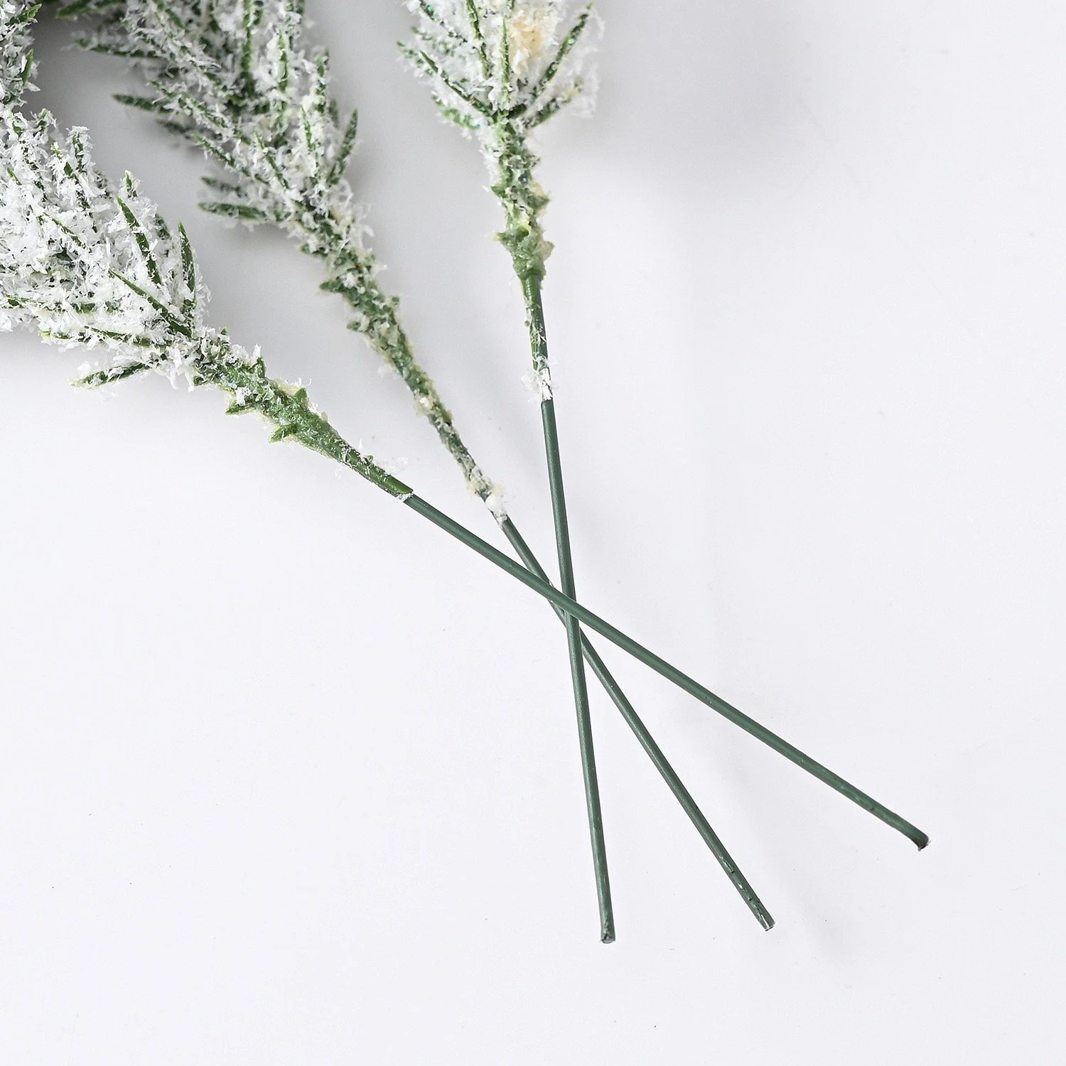 Stem detail of artificial flocked snow pine picks