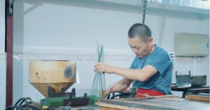 Measuring an approved artificial flower sample before production