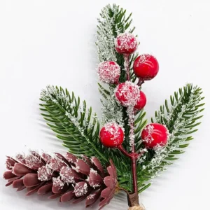 Close-up of snow-dusted red berries on an artificial Christmas pick